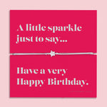 Silver bracelet on a pink card with birthday message