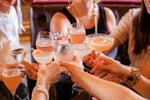 Group of people toasting with cocktails in a social setting