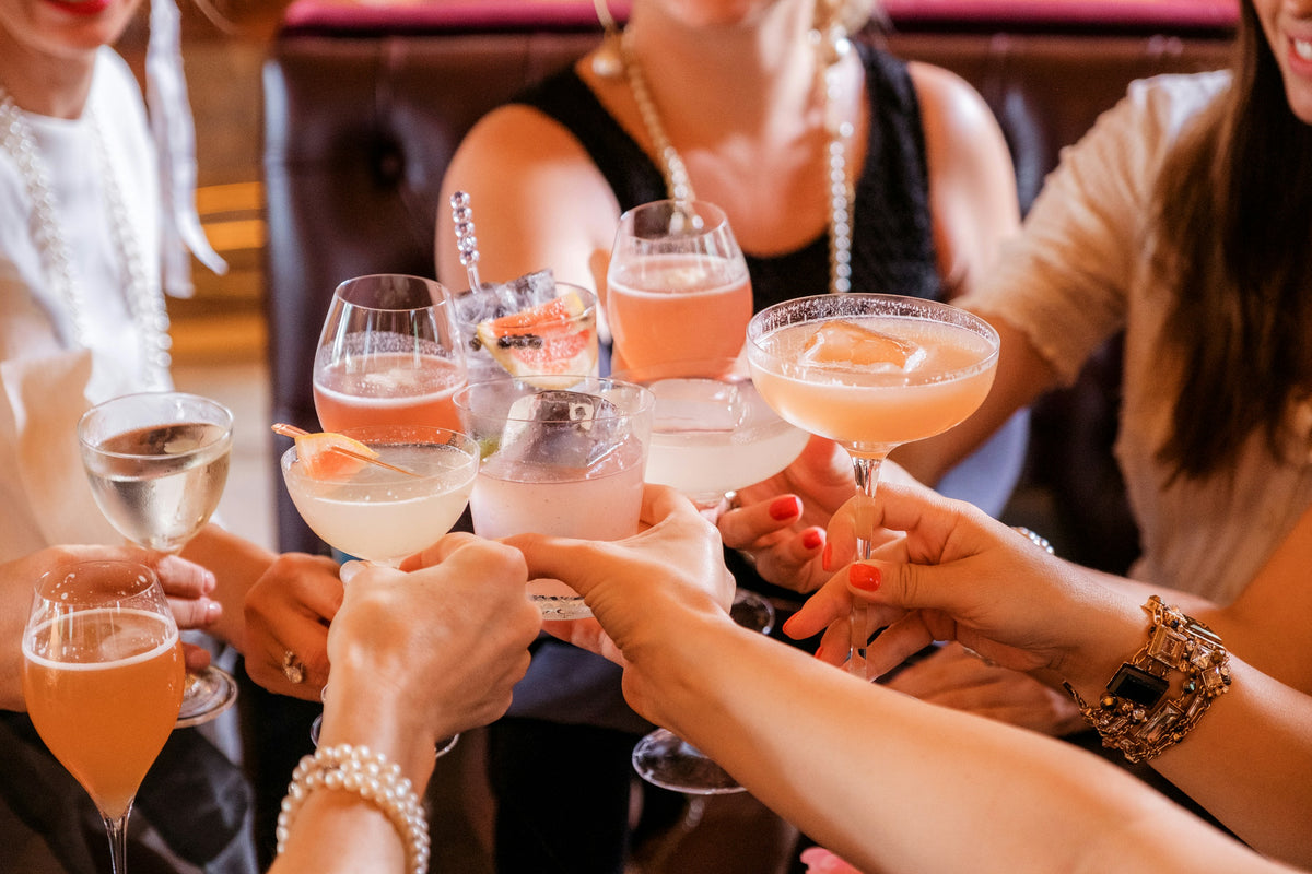 Group of people toasting with cocktails in a social setting