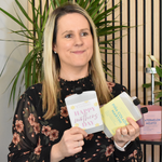Woman holding two products with letterbox cocktails in a decorative setting