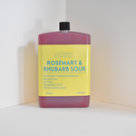 Bottle of Rosemary & Rhubarb Sour cocktail mix on a white background