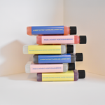 Stack of colorful bottles with text on a light background