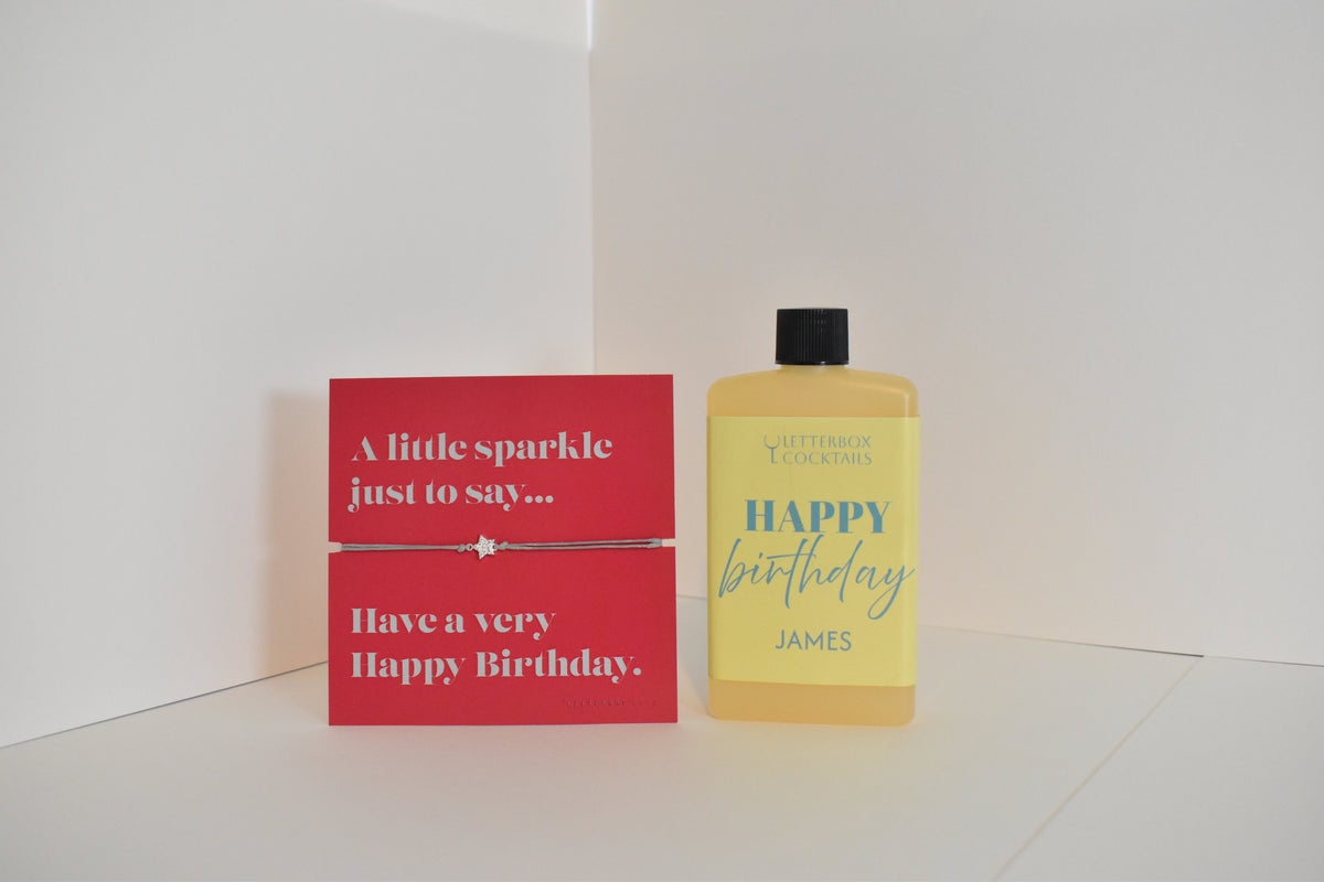 Bottle of letterbox cocktails with a happy birthday bracelet and personalised happy birthday cocktail on a white background