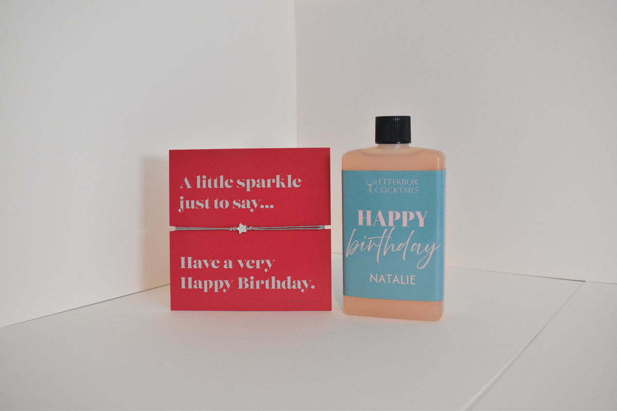 Bottle of letterbox cocktails with a happy birthday bracelet and personalised happy birthday cocktail on a white background