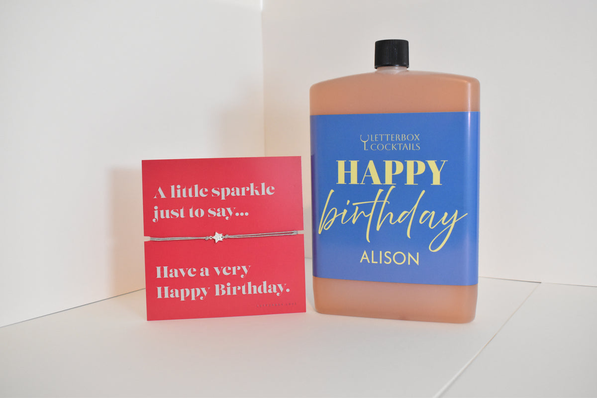 Bottle of letterbox cocktails with a happy birthday bracelet and personalised happy birthday cocktail on a white background