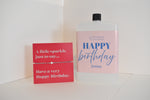 Bottle of letterbox cocktails with a happy birthday bracelet and personalised happy birthday cocktail on a white background