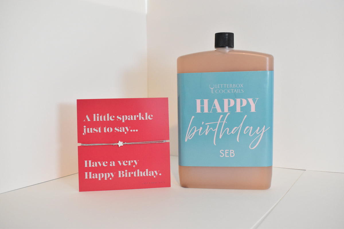 Bottle of letterbox cocktails with a happy birthday bracelet and personalised happy birthday cocktail on a white background