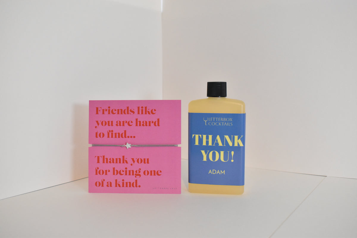 Bottle of letterbox cocktails with a pink thank you bracelet and thank you cocktail on a white background