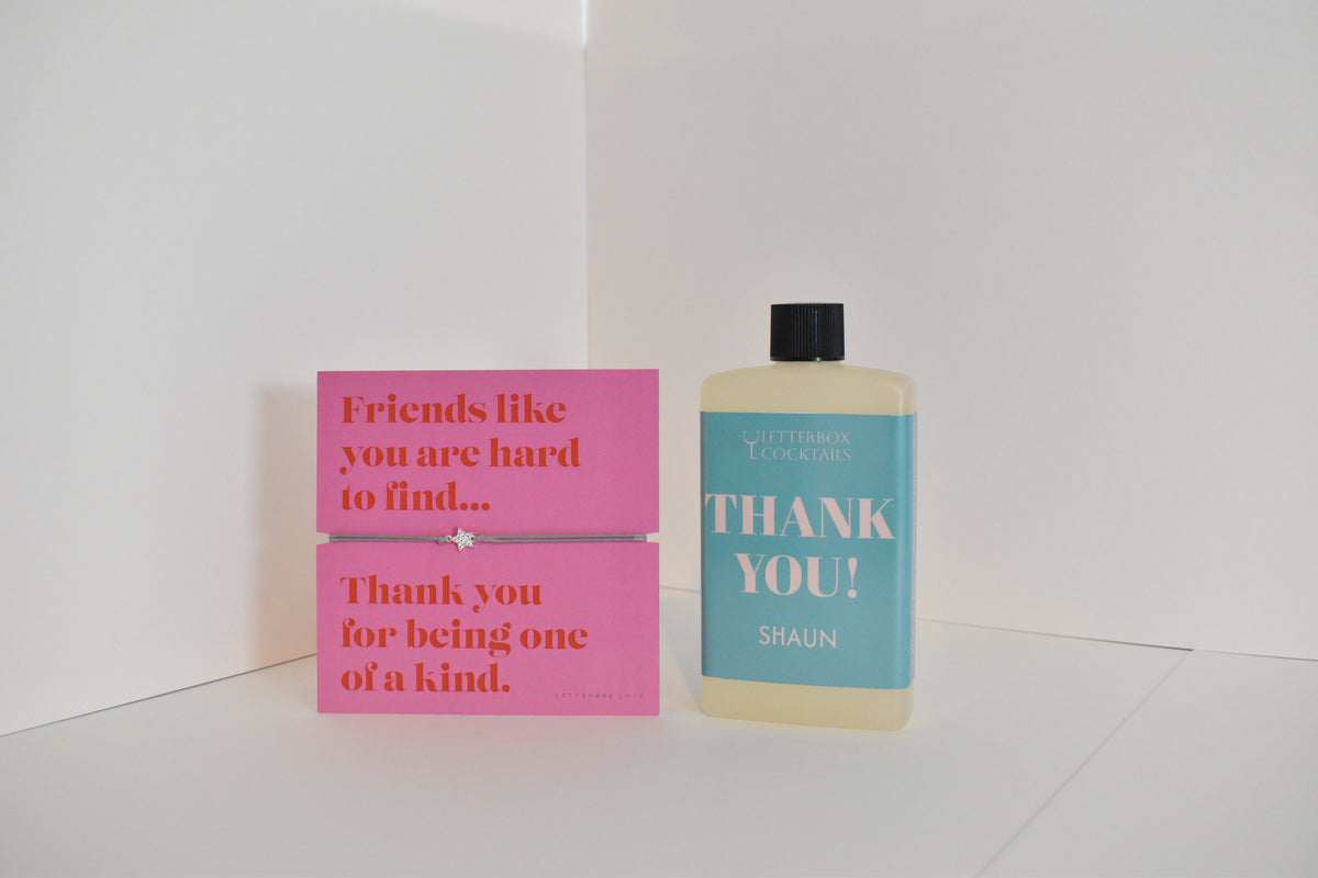 Bottle of letterbox cocktails with a pink thank you bracelet and thank you cocktail on a white background