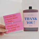 Bottle of letterbox cocktails with a pink thank you bracelet and personalised thank you cocktail on a white background