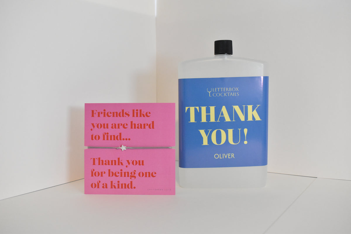Bottle of letterbox cocktails with a pink thank you bracelet and personalised thank you cocktail on a white background